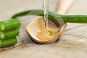 Aloe Vera gel close up. Sliced Aloevera leaf and gel with wooden spoon