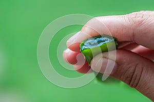 Aloe Vera leaf juice in woman`s hand