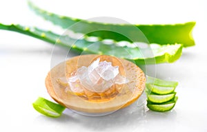 Aloe Vera leaves closeup on white wooden background. Organic sliced aloevera leaf and gel, natural organic cosmetic ingredients