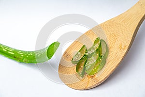 Aloe Vera plant on wooden spoon with white background