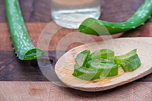 Aloe Vera sliced sitting on wooden spoon