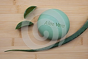 Aloe vera soap with fresh aloe vera leaf on bamboo background