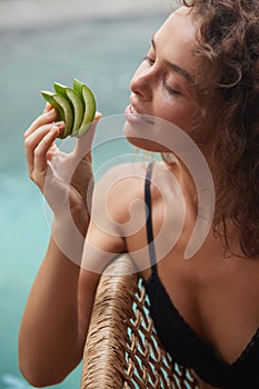 Aloe Woman. Girl Holding Slices Of Fresh Juicy Aloe Vera Leaf Near Her Face