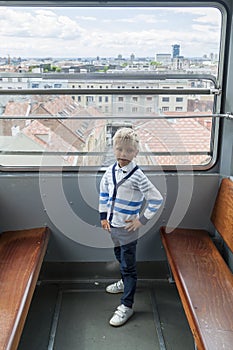 alone boy climb in an empty funicular and look at the panorama of the city of Zagreb