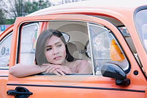 Alone girl sitting in the car and looking for waiting someone