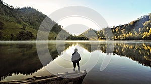 Alone man on lake indonesia morning