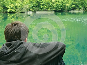 Alone meditate boy and river