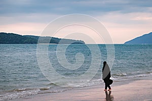 Alone Muslim Woman resting on the beach