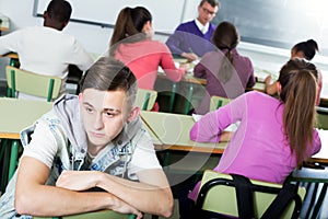 Alone outcasted student being mobbed by other students
