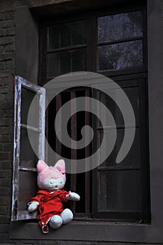 Alone rag baby at windowsill photo