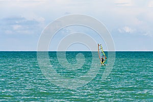 Alone surfer on board in sea with clear blue sky