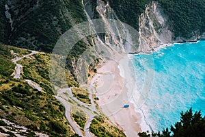 Alone tourist tent on famous Myrtos Beach. Big foam waves rolling towards the bay. Kefalonia, Greece