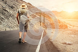 Alone traveler walks on the mountain road in indian Himalaya mountain