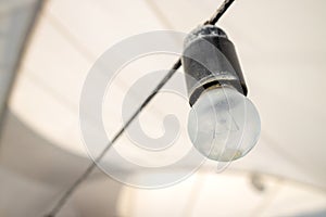 alone vintage light bulb at gray tent background. vintage lighting equipment