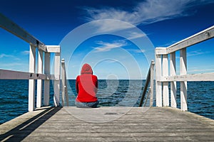 Alone Woman in Red Shirt at the Edge of Pier