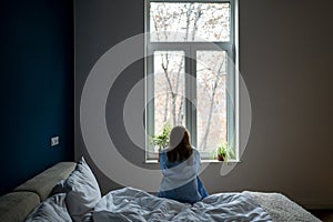 Alone woman sit on bed at home pondering solution trouble, suffer from breakup, divorce, feel unwell