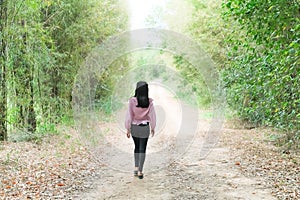 Alone Young Women Walking on Road Away in Forest at Countryside Grill on Path Way in Park Landscape,Concept for Broken Heart or