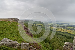 Along the front of Curbar Edge and Baslow Edge in Derbyshire on a misty, grey summer day
