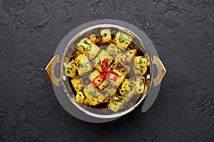 Aloo Methi in copper kadai, bowl at dark slate background. Aloo Methi is indian cuisine dish