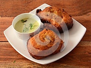 Aloo pakora or aloo bhajji served with chutney photo