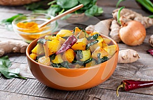 Aloo Palak sabzi / Spinach Potatoes curry served in a bowl. Popular Indian healthy recipe