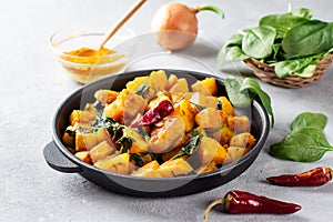 Aloo Palak sabzi or Spinach Potatoes curry served in a frying pan. Popular Indian healthy recipe