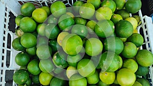 alot of green lemon in market