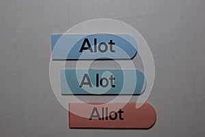 Alot, a lot, Allot write on a sticky note isolated on office desk. Learning use proper grammar photo
