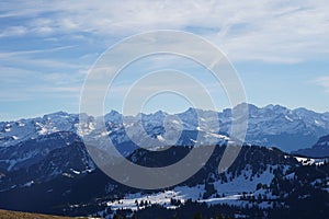 Alp mountains in Switzerland in winter under blue sky.