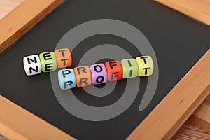 Alphabet beads with text NET PROFIT. Net profit is the amount of money your business earns after deducting all operating, and tax