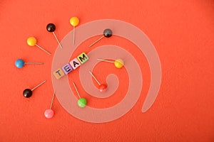 Alphabet beads with text TEAM. In a business context, a team refers to a group of individuals working collaboratively and photo