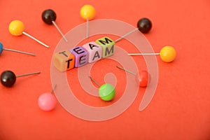 Alphabet beads with text TEAM.In a business context, a team refers to a group of individuals working collaboratively and photo