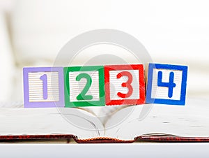 Alphabet block with 1234 on book