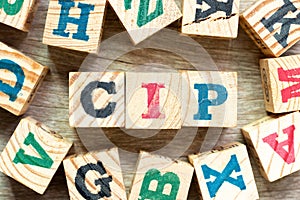 Alphabet block in word CIP Abbreviation of Carriage and Insurance Paid To with another on wood background
