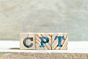 Alphabet block in word CPT (Abbreviation of Carriage Paid To) on wood background