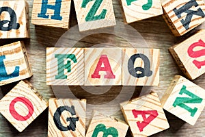 Alphabet block in word FAQ Abbreviation of Frequently Asked Questions with another on wood background