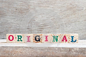 Alphabet block in word original on wood background