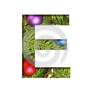 Alphabet on Christmas tree. The letter E cut out of paper on a background fresh ï¿½hristmas tree with colored balls. Set of