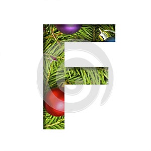 Alphabet on Christmas tree. The letter F cut out of paper on a background fresh ï¿½hristmas tree with colored balls. Set of