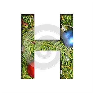 Alphabet on Christmas tree. The letter H cut out of paper on a background fresh ï¿½hristmas tree with colored balls. Set of