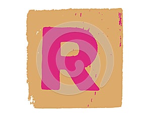Alphabet letter cube with capital letter R on a beige background