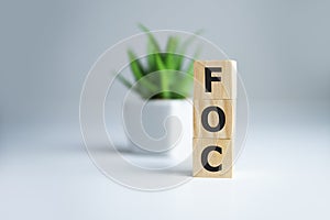 Alphabet letter in word FOC Abbreviation of Free of charge on white background photo