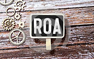 Alphabet letter in word ROA Abbbreviation of Return on assets on wood background