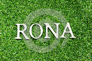 Alphabet in word RONA Abbreviation of Return on net assets on green grass background photo