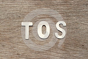 Letter in word TOS abbreviation of Terms of service on wood background photo