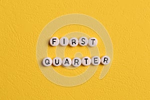 Alphabet letters with text FIRST QUARTER isolated on yellow background