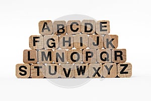 Alphabet letters on wooden cubes, isolated on white
