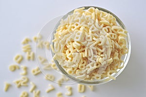 Alphabet pasta for children`s meals. ABC pasta. Dry pasta in a bowl isolated on white