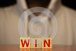 alphabet wood blocks forming the word win
