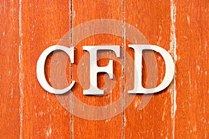 Alphabet in word CFD Abbreviation of Contract for Difference on old red color wood plate background